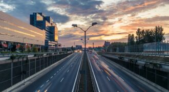timelapse photo of 2-lane road under golden sky
